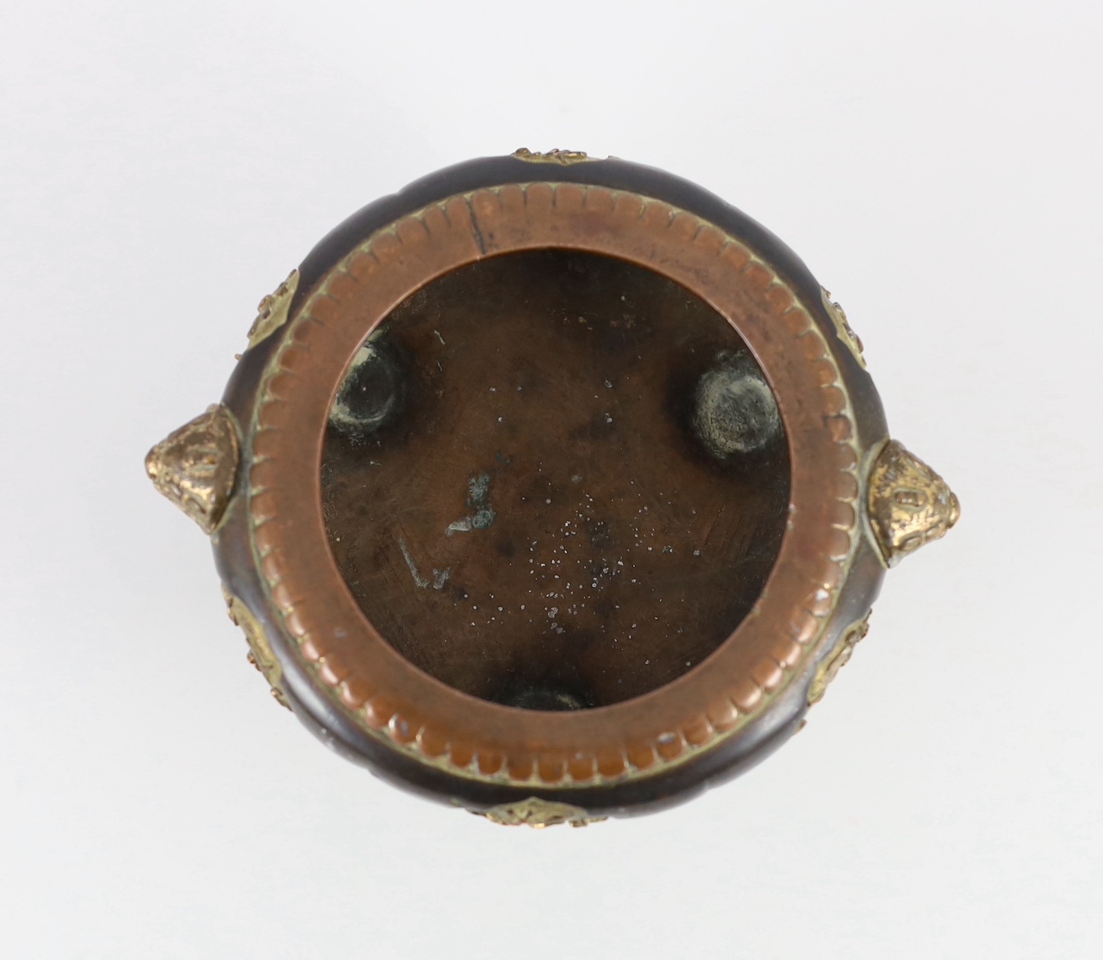 A Chinese Imperial copper alloy censer, ding, 18th century, 12cm wide 7cm high, ring handles and cover lacking, some wear.